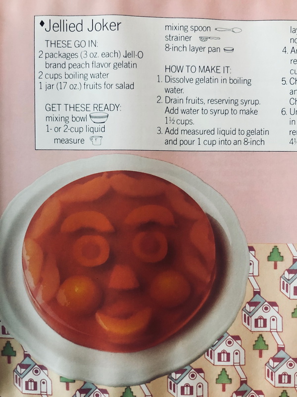 orange jello flat circle with creepy fruit for face