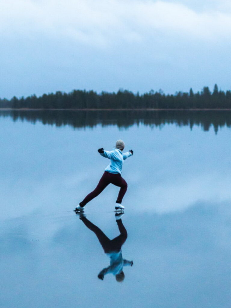figure skater Tiina Pakkanen skating on a frozen lake