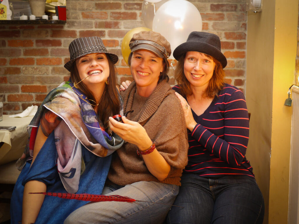 editors suzanne smith, cheryl wilder, and claire guyton pose in fun hats and accessories