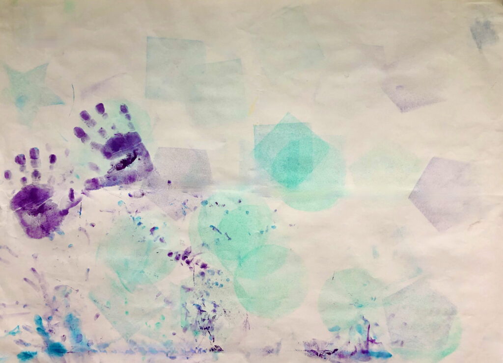 chikd's  purpole handprints on white paper with blue square sponge shapes