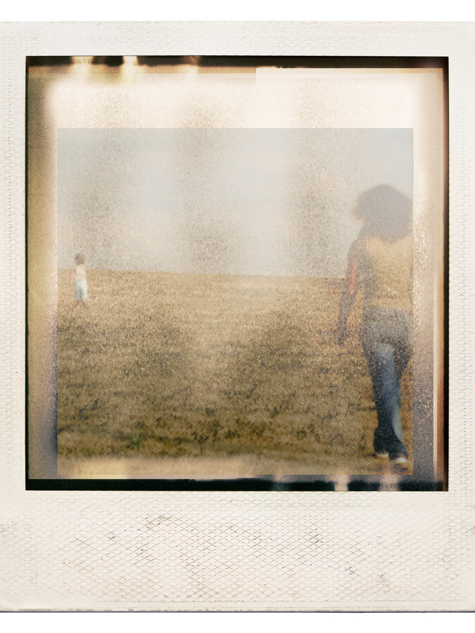 faded polariod with mother walking in foreground toward small child a ways away in the background