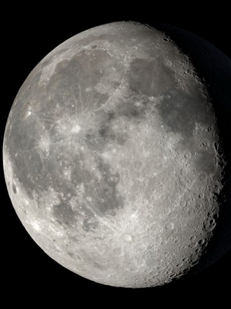 Close up of the moon as it looks on Dec. 1, 2023, when the moon is in the Waning Gibbous phase and is 82.49% full; the upper left quadrant is the darkest grey with the lower left being the lightest grey to white